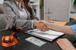 © PHOTO4U - Concept of bribery, corruption, and unethical business practices with cash offered during a legal contract meeting, highlighting financial crime, integrity, compliance, and corporate ethics.