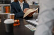 © PHOTO4U - Professional legal consultation with a lawyer explaining legal procedures, reviewing contracts, and advising clients during a case discussion in a modern law office, representing justice and trust.