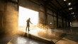 © CK Studio - Warehouse worker pressure washing floor at bay door with bright backlight and dust, industrial maintenance and facility upkeep.