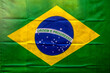 © AlfRibeiro - Full frame background texture of the vibrant green and yellow national flag of Brazil featuring the blue celestial globe with the motto Ordem e Progresso.