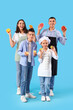 © Pixel-Shot - Happy family with citruses on blue background