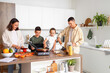 © Pixel-Shot - Happy family cooking in kitchen