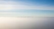 © Rohmah - Stunning aerial view of a vast cloudscape stretching to the horizon under a clear blue sky, creating a serene and expansive natural backdrop.