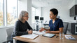 © HIJRAH - Healthcare Professional Advises Patient At Desk In Modern Clinic Setting