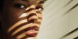 © Fun Factory - Close up artistic portrait of a young woman with glowing skin captured in soft morning light, sunlight lines filtering through window blinds creating dramatic shadows across her beautiful face