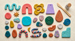 © Aromas - Kit de manualidades con arcilla polimérica de colores, herramientas de modelado, pintura y barniz sobre fondo blanco. Vista superior.