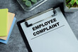 © syahrir - Concept of employee complaint write on clipboard isolated on Wooden Table. For human resource conflict resolution and office stress