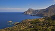 © Ralf Adler/imageBROKER - Rugged coastline with mountains and blue sea under a light cloud shadow, Mesochori village, west coast, Karpathos, Dodecanese, Greek Islands, Greece