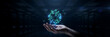 © Nasima - A human hand holds a glowing blue digital sphere made of complex interconnected lines and nodes inside a dark, blurred server room corridor