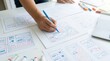 © Niam - Professional design studio workspace featuring website wireframe drawings and development prototypes.