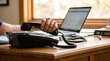 © Fozia - Professional doctor holding a black vintage telephone receiver while working at a wooden desk with a laptop computer and a stethoscope in a bright medical office setting captured from a close up side