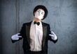 © Nomad_Soul - Mime performer tilting his head and pointing down with both hands