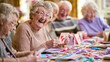© Olga Ко - joyful senior woman laughing while showing handmade greeting card with hearts at craft workshop in nursing home, elderly people enjoying card making activity together.