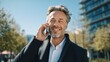 © Isrodin - Man talking on phone outdoors