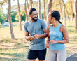 © Lumos sp - Smiling active mature mid aged couple jogging exercising and having fun and laughing together taking a break in the park