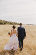 © Sarah Kathleen - Bride and Groom in a Field