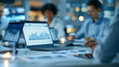 © Laura - Faceless business team in a glass conference room reviewing financial dashboards, sharing printed reports and discussing performance trends while agreeing on strategy using