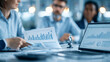 © Laura - Faceless business team in a glass conference room reviewing financial dashboards, sharing printed reports and discussing performance trends while agreeing on strategy using