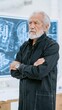 © kvladimirv - Senior Architect in Thoughtful Contemplation beside Architectural Blueprint in Modern Workspace