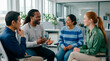 © kodidesign - Diverse colleagues in casual clothes discussing a new project in a modern office. Multiethnic team of professionals smiling and talking during a meeting. Teamwork and collaboration concept