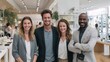 © Prapan - Confident Business Team Posing: A diverse group of four business professionals, two men and two women, stand confidently with smiles.