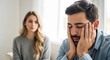 © HariBudi - Stressed man having relationship conflict with worried partner in background