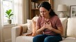 © PNG shops - A distressed young woman in a casual pink t-shirt and blue jeans clutches her chest with both hands while expressing intense physical pain and suffering during a difficult moment.