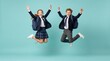 © 5 Grace Media - Two happy school children jumping high with excitement on a turquoise background.