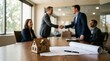 © Supernova - Real estate deal closing with handshake house model and architectural plans on table