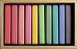 © Mariia - Colorful children's drawing chalks neatly arranged in a wooden box, symbolizing creativity, art education, school supplies, artistic expression, learning, and back to school