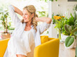 © Westend61 - Portrait of smiling mature woman relaxing in armchair at home