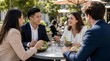 © Abu - Diverse young professionals in smart business attire laughing over fresh salads at a sunlit outdoor cafe, enjoying collaborative lunch, networking, friendship and relaxed urban work culture