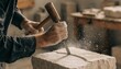 © Avijit - Close up of skilled stonemason hands chiseling a decorative groove into rough limestone block with wooden mallet, airborne dust and warm workshop light, traditional masonry craft work