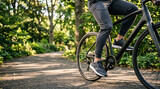 Man cycling on path in park, healthy outdoor activity, close-up on legs and bike
