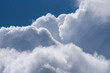 © Stephan - Dramatic view of fluffy white cumulus clouds billowing against a deep blue sky background