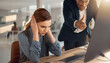 © Sri - Stressed businesswoman covering her ears while an angry male boss shouts and points at a computer screen in the office, symbolizing workplace conflict, toxic leadership, and stress