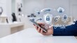 © Delilah - Hand holding smartphone with blockchain network shield and cloud security icons, mobile banking finance technology concept for secure digital transaction and cryptocurrency exch...