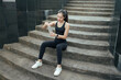 © PaeGAG - Young woman opening water bottle drinking water after workout