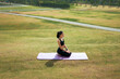 © PaeGAG - Young woman meditating on yoga mat outdoors