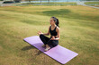© PaeGAG - Young woman meditating outdoors practicing yoga in nature