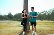 © PaeGAG - Young Asian couple resting after exercising outdoors