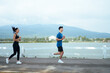 © PaeGAG - Young couple jogging outdoors enjoying morning run
