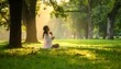 © Herlina - Serene Young Woman Sitting and Praying on Grass in Sunlit Green Park