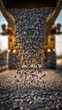 © Curioso.Photography - Close-up of crushed stone pouring from a dump truck at a road construction site, representing infrastructure, civil engineering, and aggregate materials.