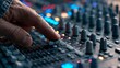 © Farah - A focused hand adjusts a knob on a professional audio mixing console, capturing the essence of sound engineering and music production