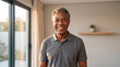 © Kaluya Stock - Happy senior African American man smiling at home in a bright modern room