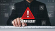 © Mdromjan22 - Businessman at keyboard with scam alert warning sign and email icons
