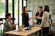 © saltdium - HR Executive Welcomes New Employees After Successful Job Interview in Modern Office Meeting Room