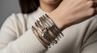 © Henderson - Woman wearing a wide silver metal cuff bracelet on her wrist with a modern fashion style