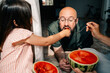 © Maria Sher/Stocksy - Father and Daughter Enjoy Watermelon Together at Home